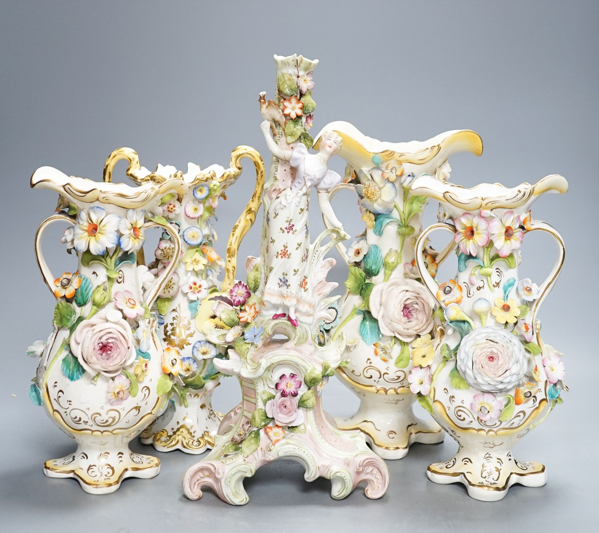 Four Coalport-type floral encrusted vases and a figural candlestick, 32cm